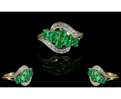 Colombian Emerald Cluster Ring, six oval cut Colombian emeralds set in a sweep across the front of the 9ct yellow gold ring, 