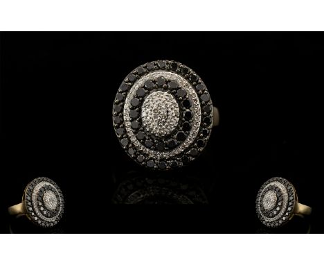 9ct Gold Black and White Diamond Set Cluster Ring - of oval shape in a very attractive flower head designed setting. Full hal