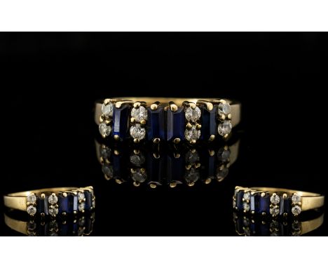 9ct Gold Chanel Set Sapphire and Diamond Ring - of pleasing design/form. The step cut sapphires with diamond spacers. Fully h