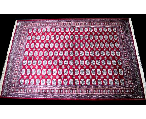 A Large Woven Silk Bokhara Carpet Ornate silk carpet with traditional lozenge and geometric repeat design with intricate bord