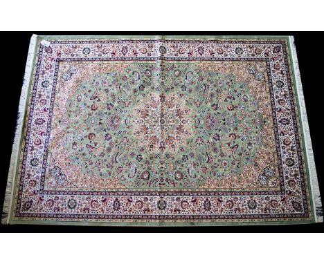 A Large Woven Silk Carpet Keshan rug with eau de nil ground and traditional Middle Eastern floral and foliate border detail w