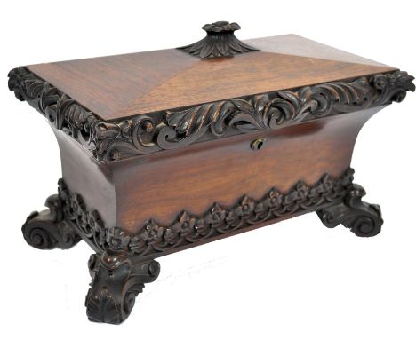 A 19th century rosewood over sized tea caddy of sarcophagus form having a concave body raised on s scroll with feet with scro