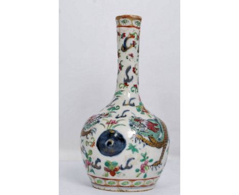 A Chinese porcelain vase being hand painted, 17th / 18th century Qing dynasty. Of baluster form with famille rose decoration 