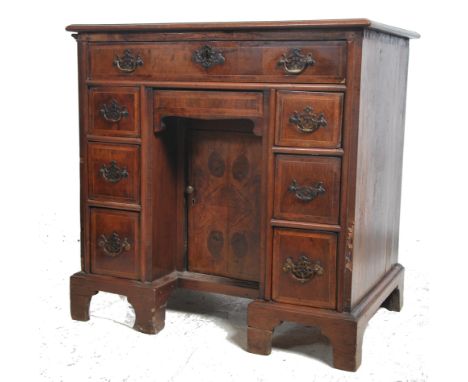 An 18th century Queen Anne walnut kneehole desk of small proportions having bracket legs with pedestals of drawers flanking a