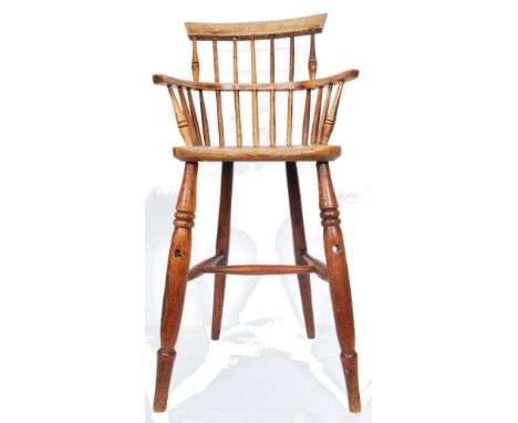 A 19th century country elm childs high chair. Raised on turned legs with h-stretcher having an elm saddle seat with turned ra