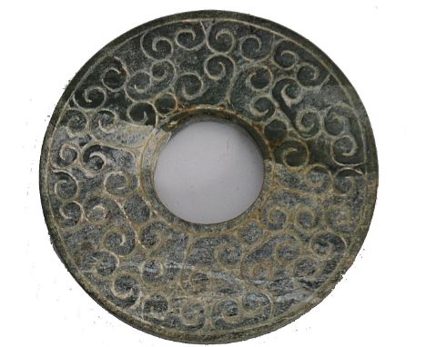 A Chinese Jade Bi having repeating scrolling motifs, Han style believed to date to the ming dynasty. Ex estate collection of 