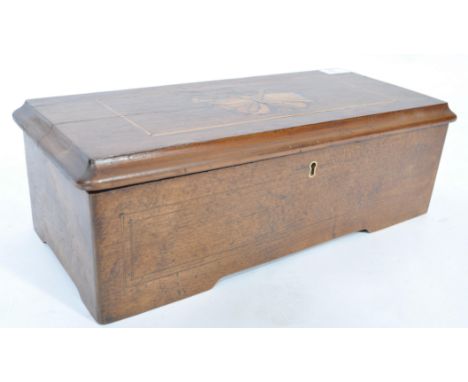 A Georgian 19th century mahogany and marquetry inlaid cylinder music box having hinged lid with inset brass cylinder movement