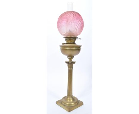 A late 19th century Victorian brass oil lamp and shape by Maple &amp; Co, London. The brass lamp with fabulous cranberry glas
