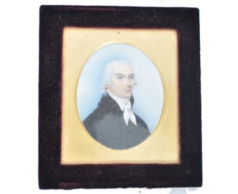 A 19th century portrait miniature painting on ivory plaque depicting a young parson - gentleman. . Set within oval gilt mount