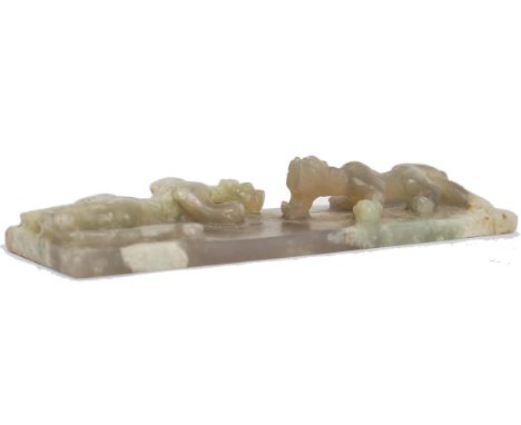 A Chinese jade plaque or scroll weight of rectangular form being carved with 2 fighting dragons, believed qing dynasty. Ex es
