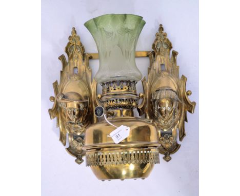 A Victorian French Art Nouveau brass twin branch wall mounted oil lamp with scrolling mask heads&nbsp; on scrolled acanthus s
