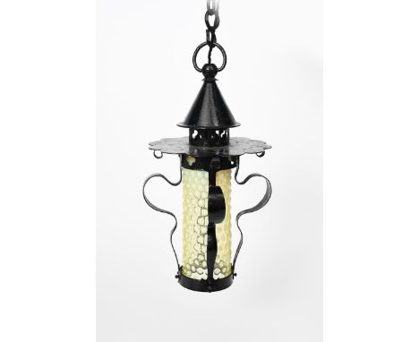 A Gothic Revival black painted metal hall lantern, the slender circular section with scroll supports, the foliate section man