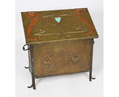 An Arts and Crafts brass box with hinged cover,  for coal or boots, brass over wood, with wrought iron handles and feet, the 