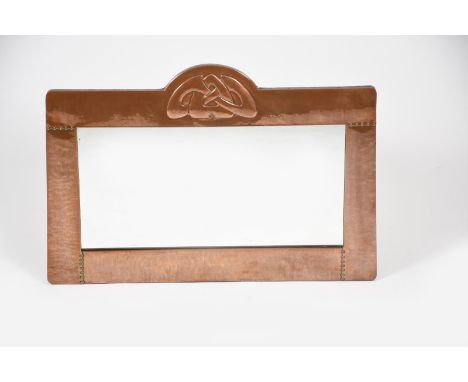 A Liberty &amp; Co copper wall mirror designed by Archibald Knox,  rectangular form with arched panel stamped in low relief w