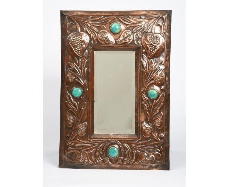 An Arts and Crafts patinated copper wall mirror,  rectangular, stamped in relief with flowers and foliage, set with four Rusk