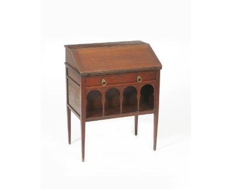 A Liberty &amp; Co Anglo-Persian mahogany bureau, on four tapering legs, with arched under carriage shelf, applied paper labe