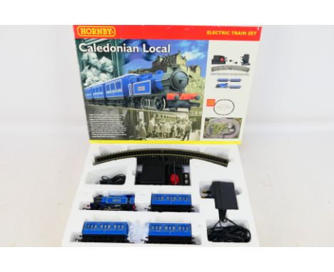 Hornby - A boxed OO gauge Hornby R1016 'Caledonian Local' electric train set. Lot contains 0-4-0 locomotive, three coaches, t