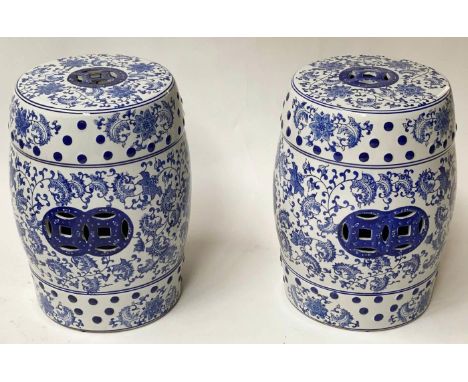 CHINESE STOOLS, a pair, 45cm H pierced blue and white ceramic, of barrel form. (2) 