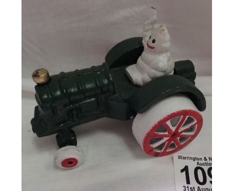 Cast iron Michelin man on a tractor, H: 8 cm. P&amp;P Group 1 (£14+VAT for the first lot and £1+VAT for subsequent lots) 