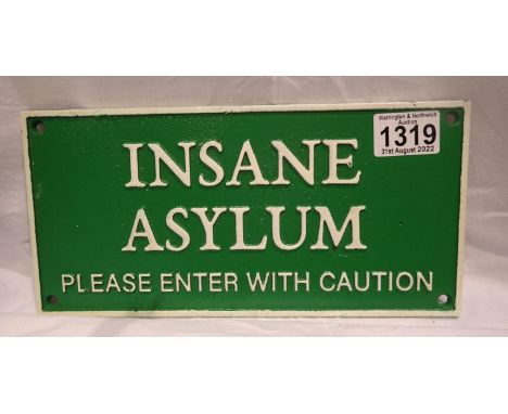 Cast iron insane asylum sign, W: 27 cm. P&amp;P Group 2 (£18+VAT for the first lot and £3+VAT for subsequent lots) 
