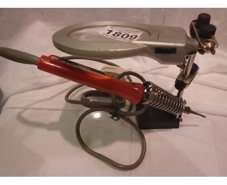 Weller 15w soldering iron on stand with magnifying glass. All electrical items in this lot have been PAT tested for safety an
