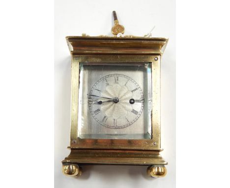 A Georgian brass cased travel clock, engine turned white metal dial bearing Roman numerals, French verge escapement by Chamoi