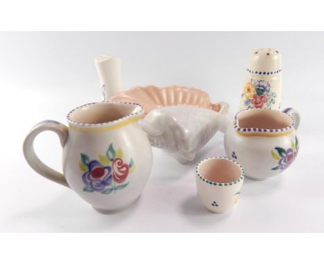 A Carter Stabler Adams Poole pottery flour sifter, traditionally painted with flowers, Poole pepperette, two cream jugs, an e