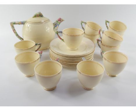 A Wedgwood & Co Art Deco pottery part tea service, with floral chintz handles and knops, comprising teapot, twelve cups and e