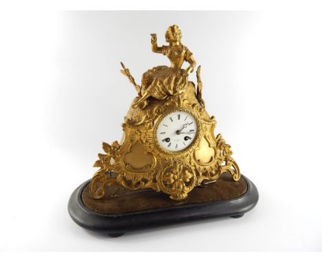 A French late 19thC gilt metal mantel clock, enamel dial bearing Roman numerals, retailed by Hny Marc a Paris, eight day move