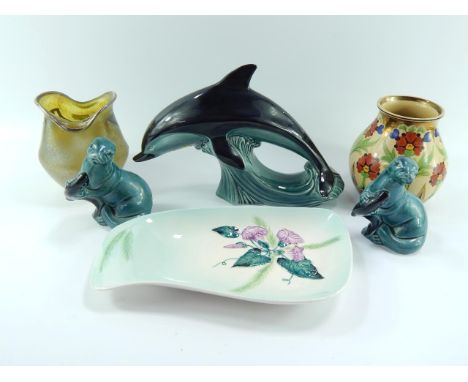 An early 20thC iridescent glass vase with silver overlay, pottery vase painted with flowers, Poole dolphin and a pair of seal