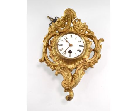A late 19thC gilt metal cased wall clock, enamel dial bearing Roman numerals, single barrel thirty hour movement, the case ca