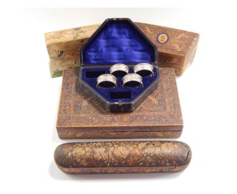 An Indian 19thC lacquer stationery box and rack, decorated with flowers and botehs, rack bearing a crest and motto 'Spero', l