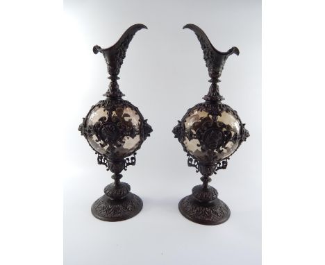 A pair of Continental late 19thC glass and bronze mounted ewers, of baluster form, cast with satyr's heads, lion's heads, por