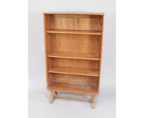 An Ercol elm bookcase, with four open shelves, raised on turned supports united by a stretcher, 76cm x 30cm x 130cm.