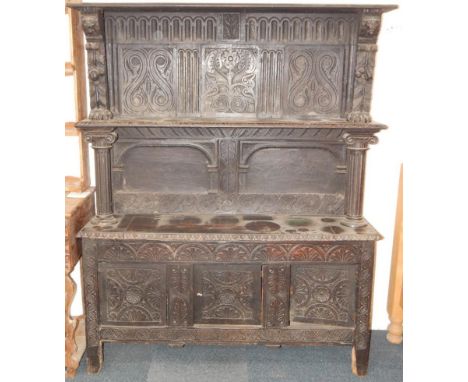 A Victorian oak dresser, the back with carved panelling, single shelf with lion's head monopodia and ionic column supports, a