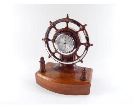 A Celeste capstan wheel mantel clock, silvered dial bearing Roman numerals, the wooden base fronted with a pair of lighthouse