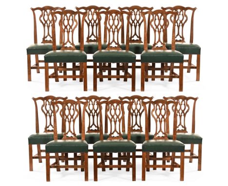 A set of fourteen Chippendale style dining chairs, each with yoke shaped top rail, pierced and carved splat back with stuffov