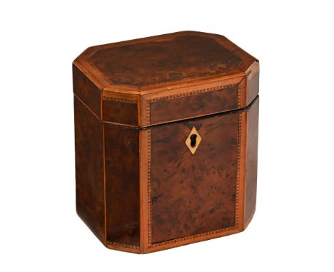 A George III burr wood and satinwood tea caddy, with canted angles and lidded interior.  Height 12 cm, width 12 cm, depth 9.5