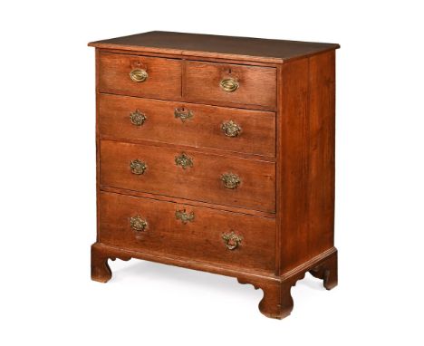 A 19th century oak chest of drawers, two short and three long with brass drop handles with oval backplates and raised on brac