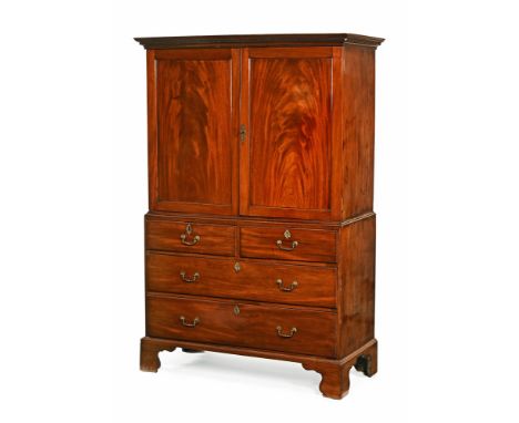 A Georgian mahogany linen press, with moulded Greek key cornice above a pair of well figured doors opening to pull out trays.