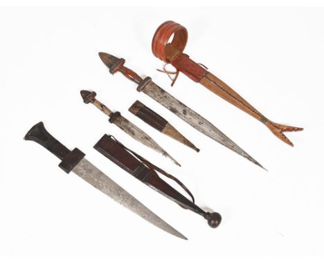 Three African hunting daggers, each with scabbard.  Longest total length 56.5 cm.  This bladed product is not for sale to peo