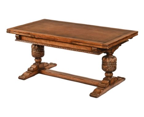 An Elizabethan style oak drawer leaf refectory table, with carved end supports centre stretcher and sledge feet.  Height 73 c