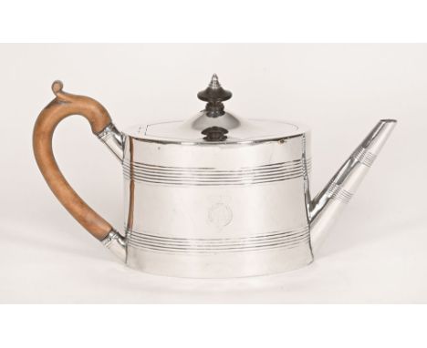A George III silver teapot, with wooden handle and ribbed design, also showing the remains of a crest to one side topped with