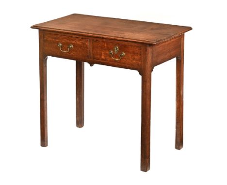 A George III oak side table or lowboy, fitted with two frieze drawers and raised on moulded legs.  Height 72 cm, width 81 cm,