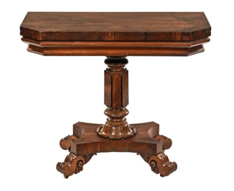 A William IV rosewood turnover top tea table, with faceted column, quatreform base and scroll legs with castors beneath.  Hei