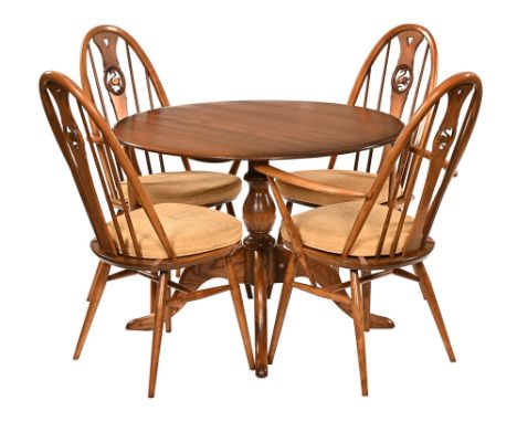 An Ercol circular dining table, with two arm and two single chairs.  Table diameter 101 cm, each armchair height to top of ba