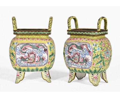A pair of enamel vessels, decorated in yellow, pink and blue with dragons to either side and grotesque masks to the feet.  He