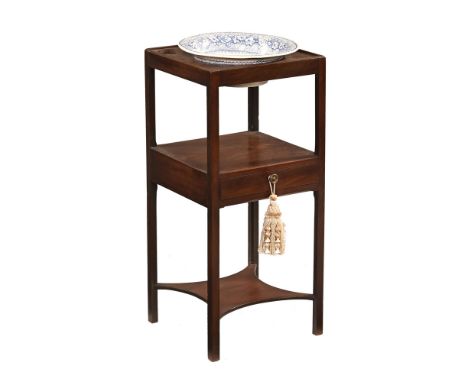 A Georgian mahogany washstand, with three aperture top, shelf and single drawer and further shelf below, comes with a blue an