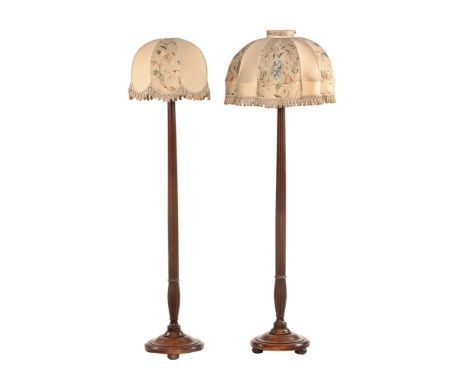 A pair of mahogany lamp standards, formerly early 19th century bedposts, each with circular base.   CONDITION REPORT:  Both s