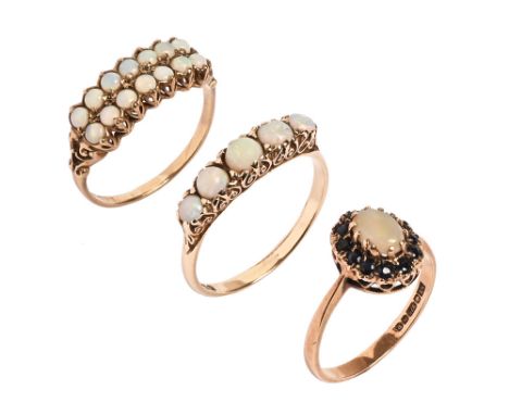 Three 9 ct gold opal rings.  Sizes P, T and R.